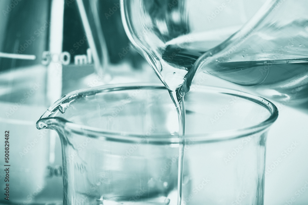 Oil pouring, Laboratory and science experiments, Formulating the chemical for medical research, Quality control of petroleum industry products concept. Oil pouring, Laboratory and science experiments, Formulating the chemical for medical research, Quality control of petroleum industry products concept.