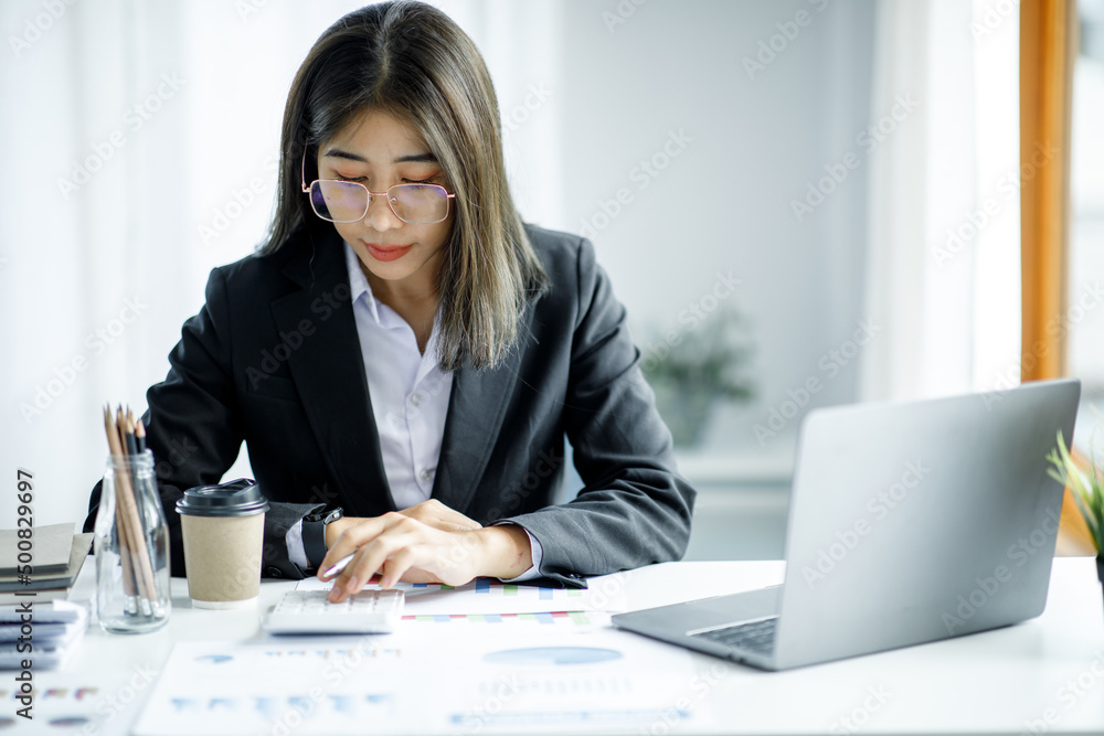 Portrait of young Asian businesswoman using write notebook laptop in home office. Beautiful girl at desk computer take home order. Startup business asia woman online sme telemarketing. Portrait of young Asian businesswoman using write notebook laptop in home office. Beautiful girl at desk computer take home order. Startup business asia woman online sme telemarketing.