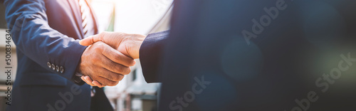 Businessman and businesswoman shaking hands, business deals and congratulations on success concept, image panorama for cover design.