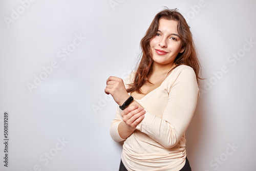 Girl with a fitness bracelet on her arm. Modern gadgets and digital technologies in human life.