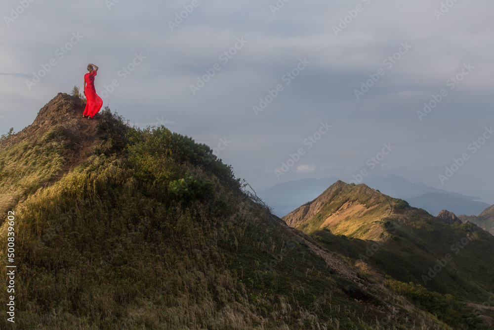 a girl in a red dress on a mountain. Sakhalin. Kuriles