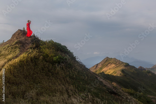 a girl in a red dress on a mountain. Sakhalin. Kuriles