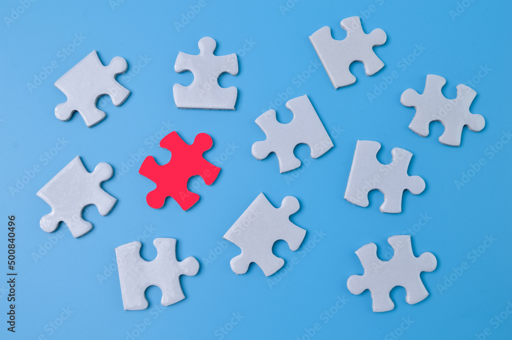 Unique red piece of puzzle among white puzzles. Society, social group, leadership qualities and talent concept Unique red piece of puzzle among white puzzles. Society, social group, leadership qualities and talent concept