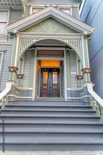 Entrance exterior of a victorian house with gray doorsteps at San Francisco, California