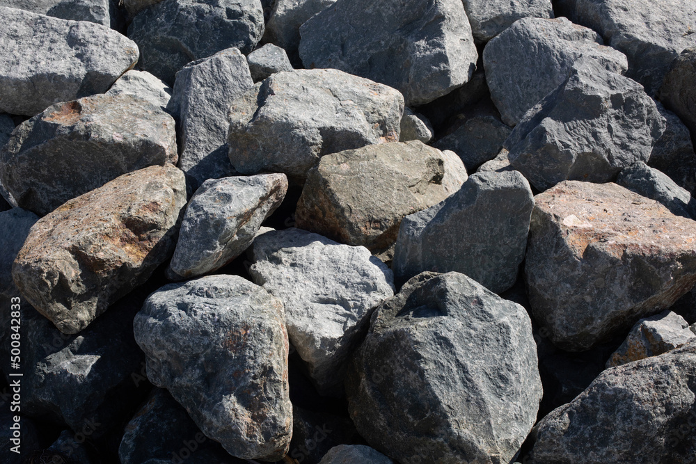 Large rocks in the pile on the beach