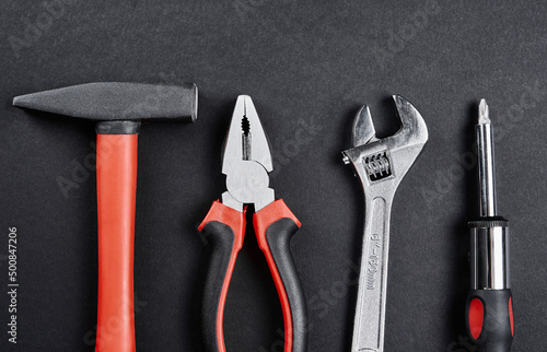 Wallpaper Mural Set of renovation tools. Instruments for repair and maintenance. Hammer, wrench, screw and tongs on black background, top view flat lay Torontodigital.ca