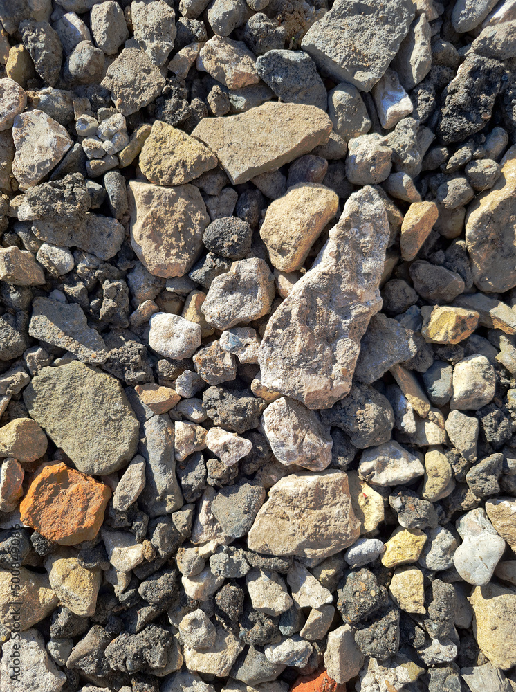 photo of building stones, rubble in sunlight of different shapes like cement and brick background for the whole format close-up