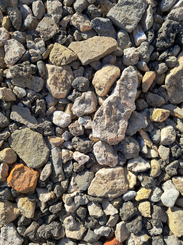 photo of building stones, rubble in sunlight of different shapes like cement and brick background for the whole format close-up