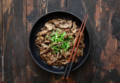 bulgogi with rice on wooden background, korean food, top view, copy space photo