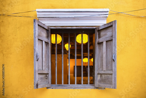 Yellow wall in Hoi an Vietnam with a window view.