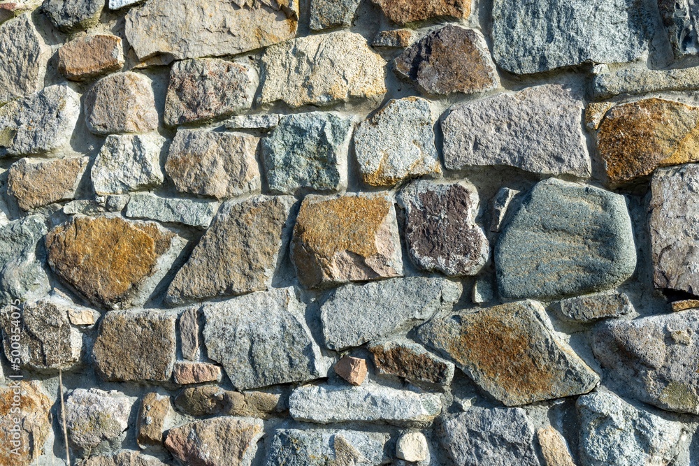 Background from a wall with stones in sunlight Background from a wall with stones in sunlight