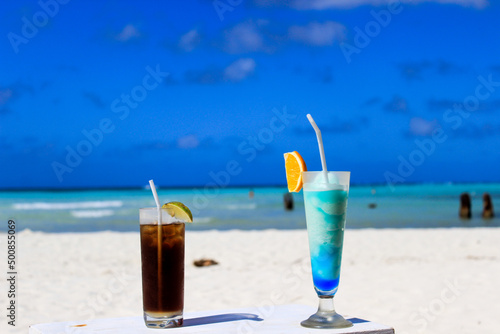 beach summer cocktails on blue sea background 