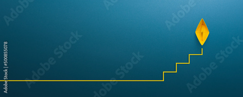 Ladder of success in business growth concept with yellow paper ship floating as step stair, copy space photo