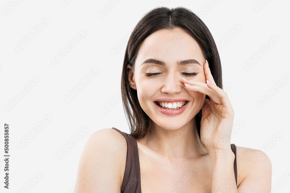 Joyful young woman closeup beauty portrait, Beautiful girl laughing and touching her face isolated on white background Joyful young woman closeup beauty portrait, Beautiful girl laughing and touching her face isolated on white background