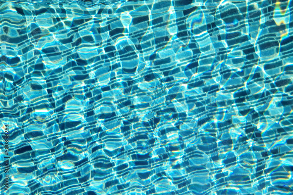 Fototapeta premium Blue ripped water an and mosaic tiles in swimming pool