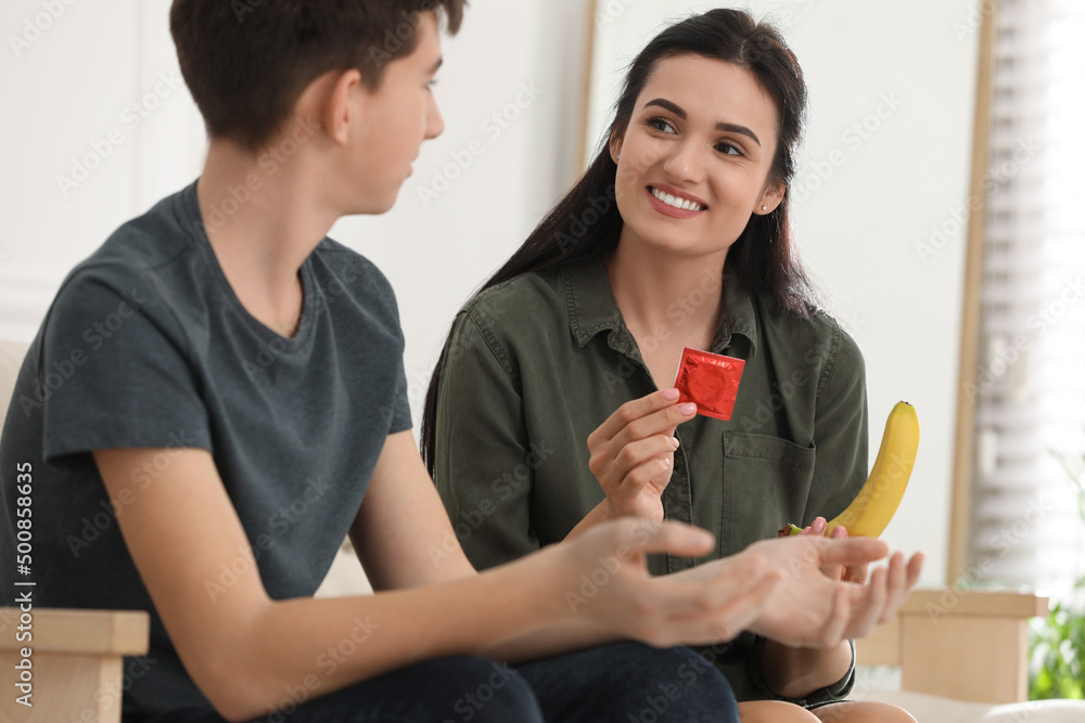 Mother Talking With Her Teenage Son About Contraception At Home Sex Education Concept Stock