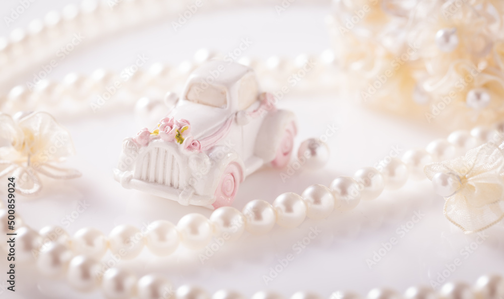 Wedding still life with golden rings and pearl necklace in white Wedding still life with golden rings and pearl necklace in white