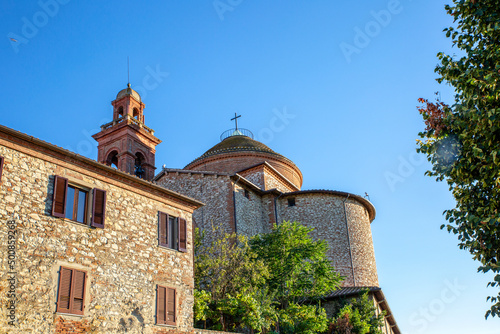 View of church under blue sky on sunny day, Castiglione del Lago, Umbria, Italy photo