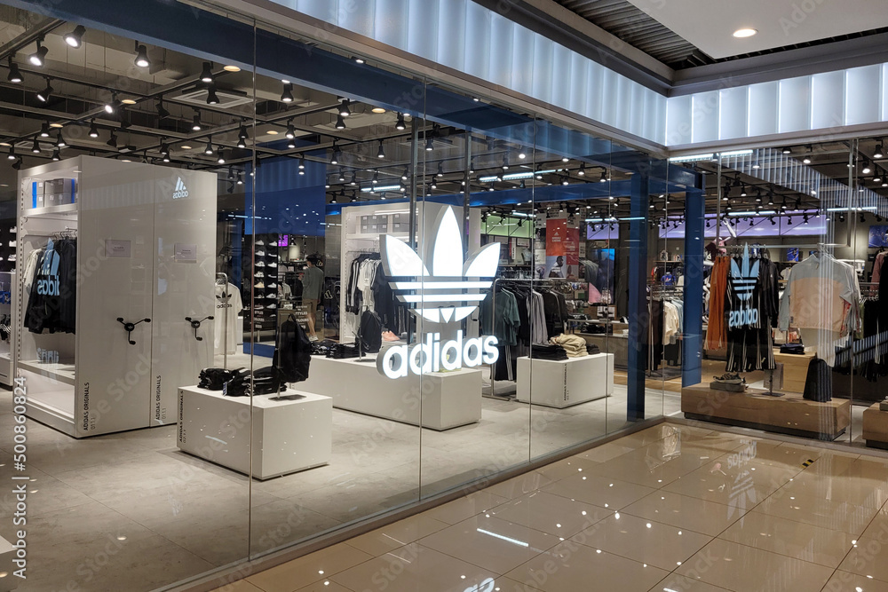 PENANG, MALAYSIA - 31 MAR 2022: interior view of Adidas store in shopping Mall, Penang. is a German corporation that designs and manufactures shoes, clothing and accessories. Stock Photo | Stock