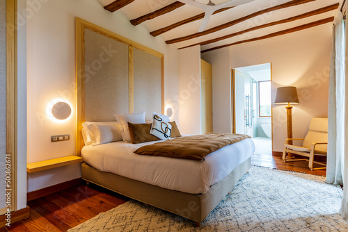 Interior of illuminated luxurious bedroom at hotel photo
