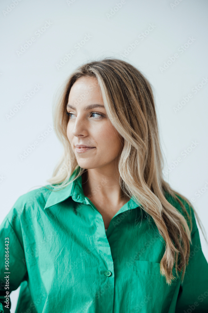 Woman with blond hair standing against white background Woman with blond hair standing against white background