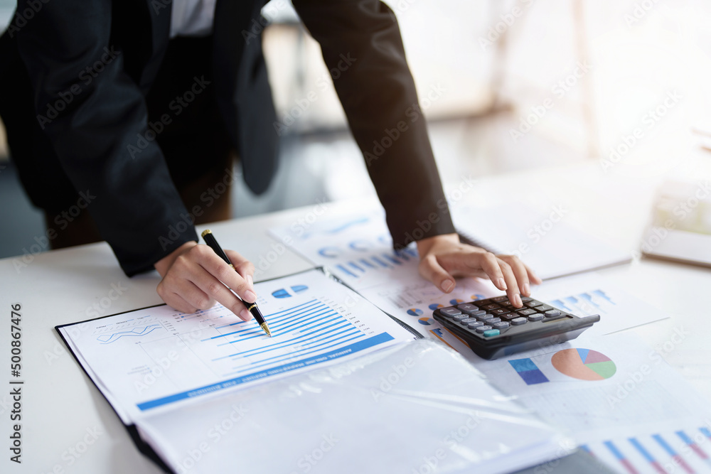 data analysis, plan, marketing, accounting, audit, asian business woman holding pen of planning marketing using statistical data sheet and calculator to present marketing plan project at meeting. data analysis, plan, marketing, accounting, audit, asian business woman holding pen of planning marketing using statistical data sheet and calculator to present marketing plan project at meeting.