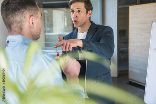 Angry businessman arguing with colleague in office