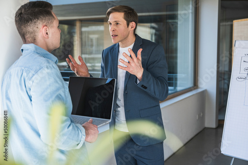 Angry businessman arguing with colleague in office