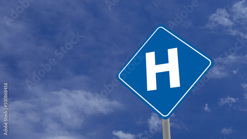 Hospital or H Road Sign on Clear Blue Sky with Rapid Moving Clouds for Text Placement