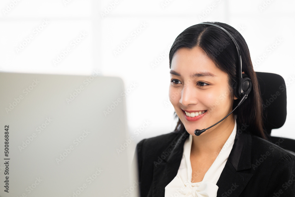Call centre female operator. Smiling asian business woman receptionist wearing headphone video conference calling talk by webcam in online chat customer support service. Call centre female operator. Smiling asian business woman receptionist wearing headphone video conference calling talk by webcam in online chat customer support service.