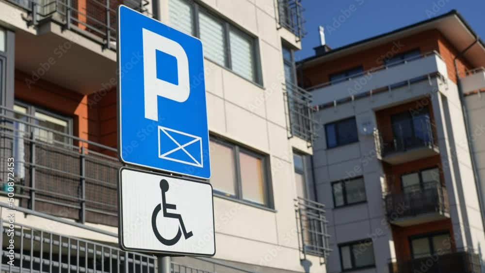 Road sign on parking site with warning about place for disabled people. Parking place for cars of people with disability Road sign on parking site with warning about place for disabled people. Parking place for cars of people with disability