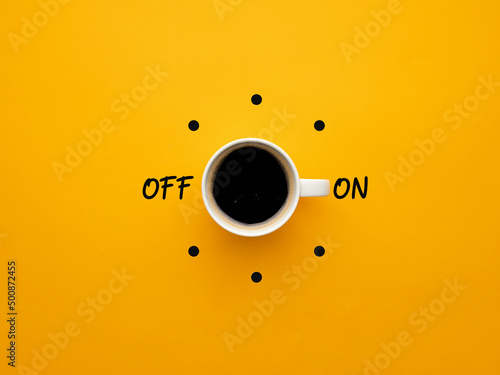Coffee cup switch on off concept on yellow background. Morning wake up coffee break concept.