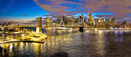 Epic skyline of New York City downtown and Brooklyn bridge evening view