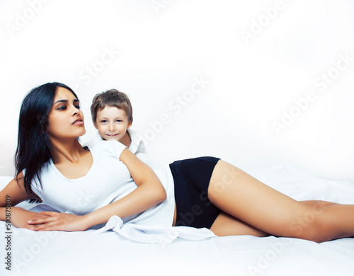 cute little boy in bed with mother in pajamas having fun happy smiling, lifestyle people concept
