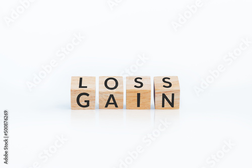 turn loss into gain concept, wooden cube with word LOSS flip to GAIN. capital investment gain and loss, financial while managing assets e.g. bonds, stocks, derivatives, ETFs, Crypto currency, forex photo