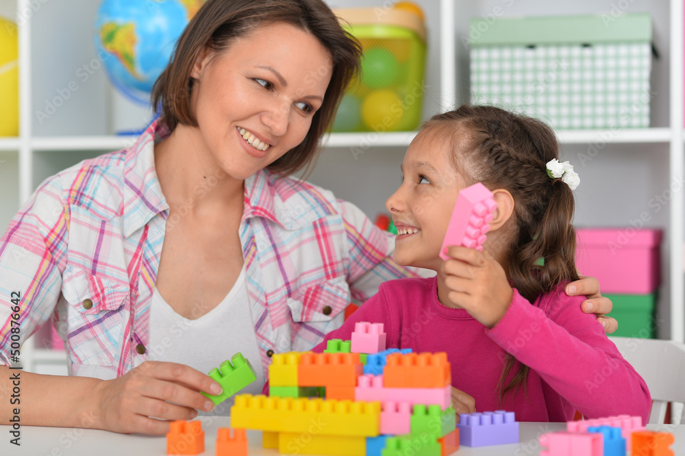 Cute little girl playing with colorful clay blocks at home Cute little girl playing with colorful clay blocks at home