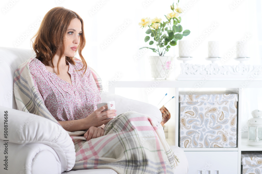 Young woman sitting in armchair Young woman sitting in armchair
