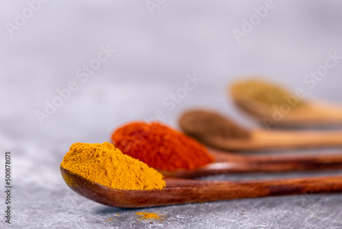 Spoonfuls of Colourful Spices Against a Grey Background