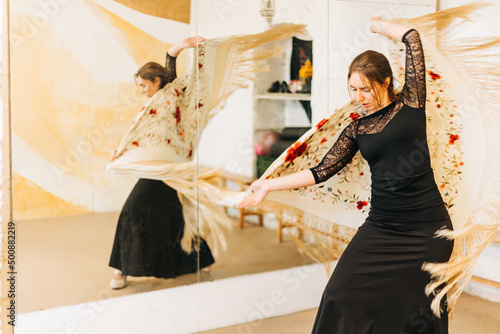 Flamenco female dancer with shawl in motion