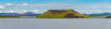 Panoramic view of pseudo craters, volcanoes and geothermal areas near Skutustadir and lake Myvatn in Iceland, summer with blue sky.