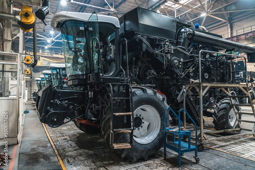 Process of assembly agricultural vehicle combine harvester in industrial factory workshop.