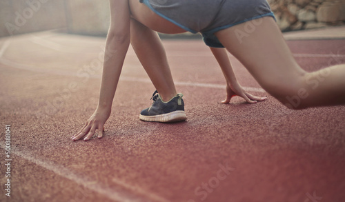 detail of woman legs on the track ready to go