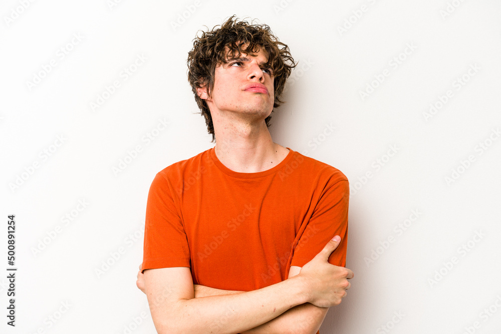 Young caucasian man isolated on white background tired of a repetitive task. Young caucasian man isolated on white background tired of a repetitive task.