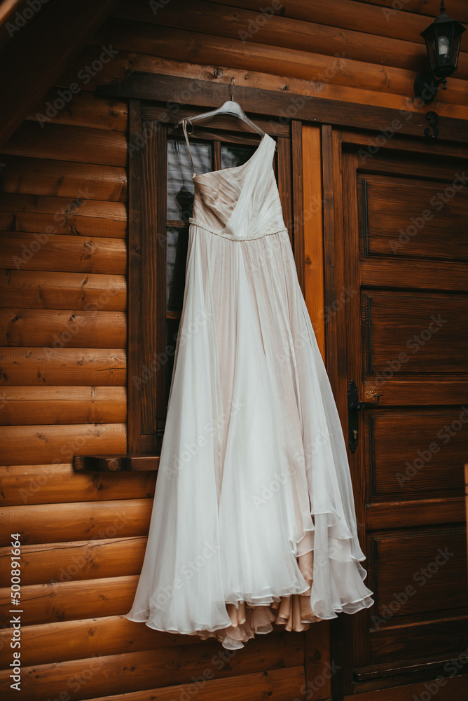 Beautiful wedding dress on a hanger stock photo.