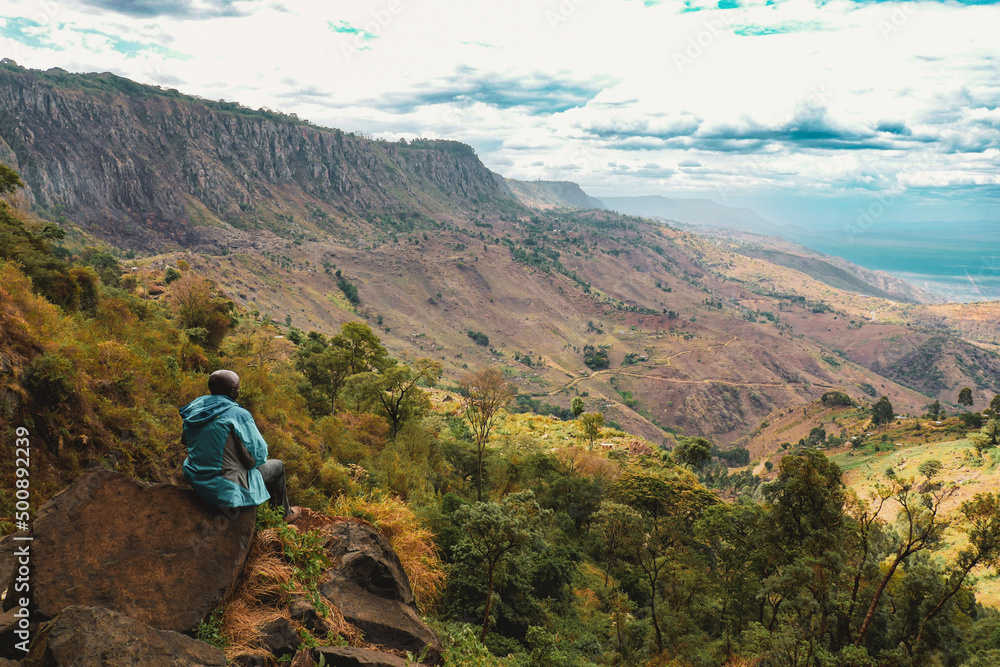 Rear view of a hiker at a scenic view point in Kerio Valley, Elgeyo Marakwet, Kenya