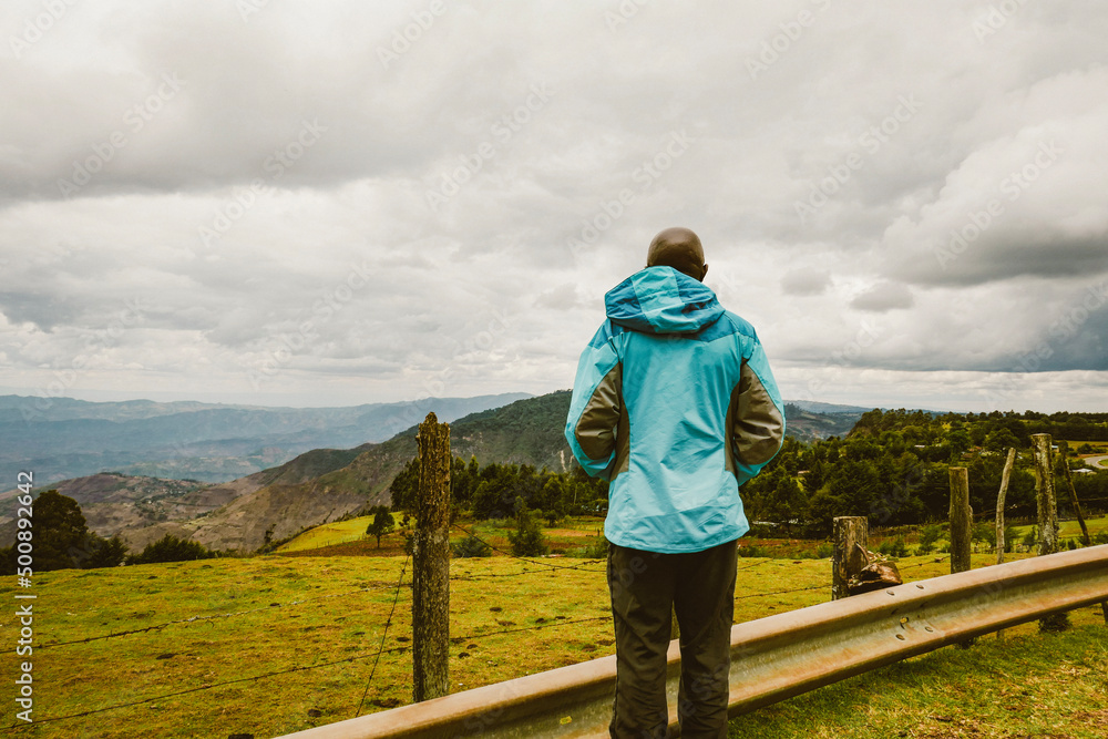 Rear view of a hiker at a scenic view point against Kerio Valley, Rift Valley, Kenya