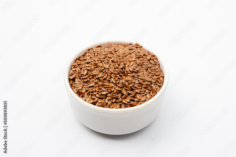 Flaxseed in white bowl on white background Flaxseed in white bowl on white background