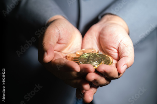 Businessman showing bitcoin cryptocurrency