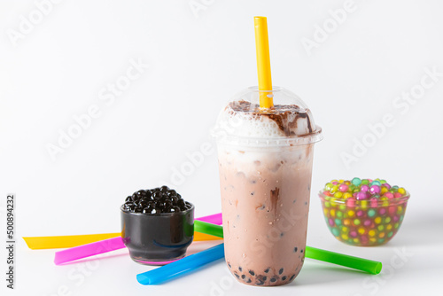 Traditional beverage of asia taiwan,  Ice buble or boba milk tea in plastic cup with straw on white background, summers refreshment. photo