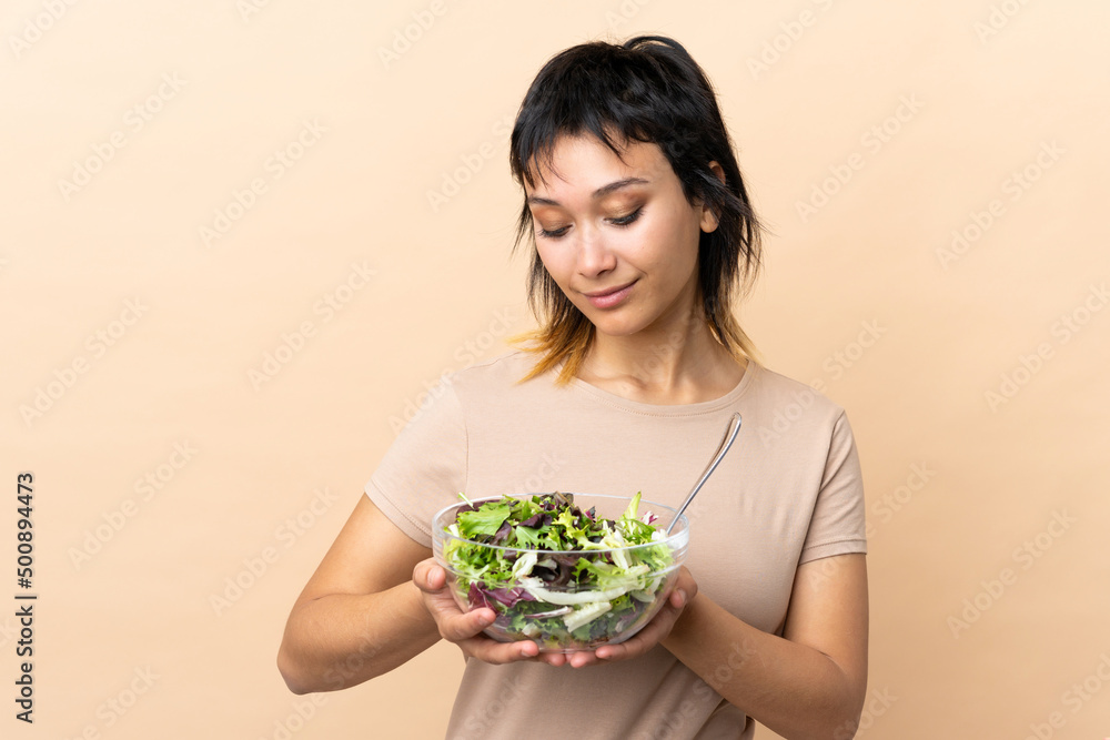 Young Uruguayan woman with salad over isolated wall Young Uruguayan woman with salad over isolated wall
